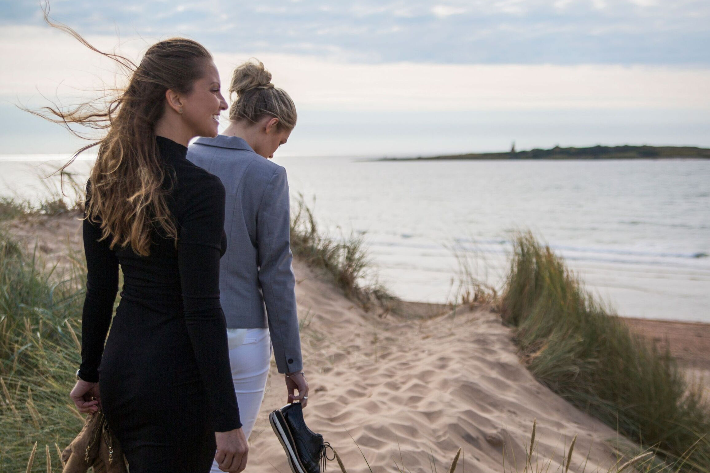 Hotel Tylösand Två tjejer promenerar i solnedgång sanddyna